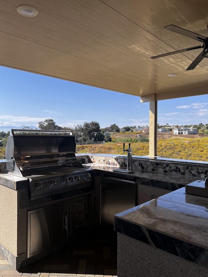 Island return with Zephyr outdoor kegerator, PCM storage under the Lion 40 inch grill, and raised bar with fire feature