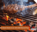 A massive tomahawk steak on gas grill grates roasting over glowing coals inside a premium Lion charcoal tray upgrade