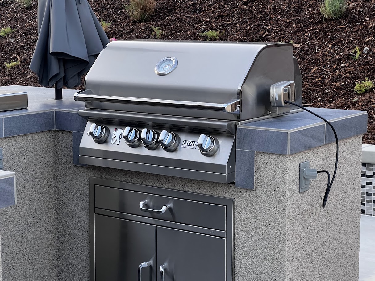 Lion L75000 32-inch gas grill on outdoor kitchen island for smoked chicken wings on a gas grill
