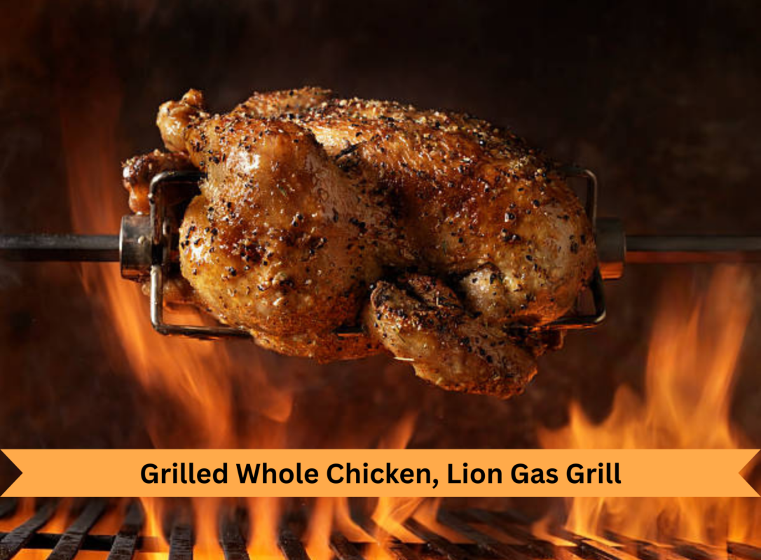 Grilled whole chicken on a gas grill turning on a rotisserie spit over open flames
