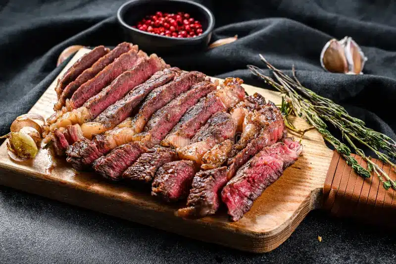How to grill a ribeye on a gas grill: sliced medium-rare grilled ribeye steak with a seared crust