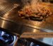 Chicken fajitas on a griddle: seasoned chicken, peppers, and onions sizzling on the included Lion Premium Grill griddle plate