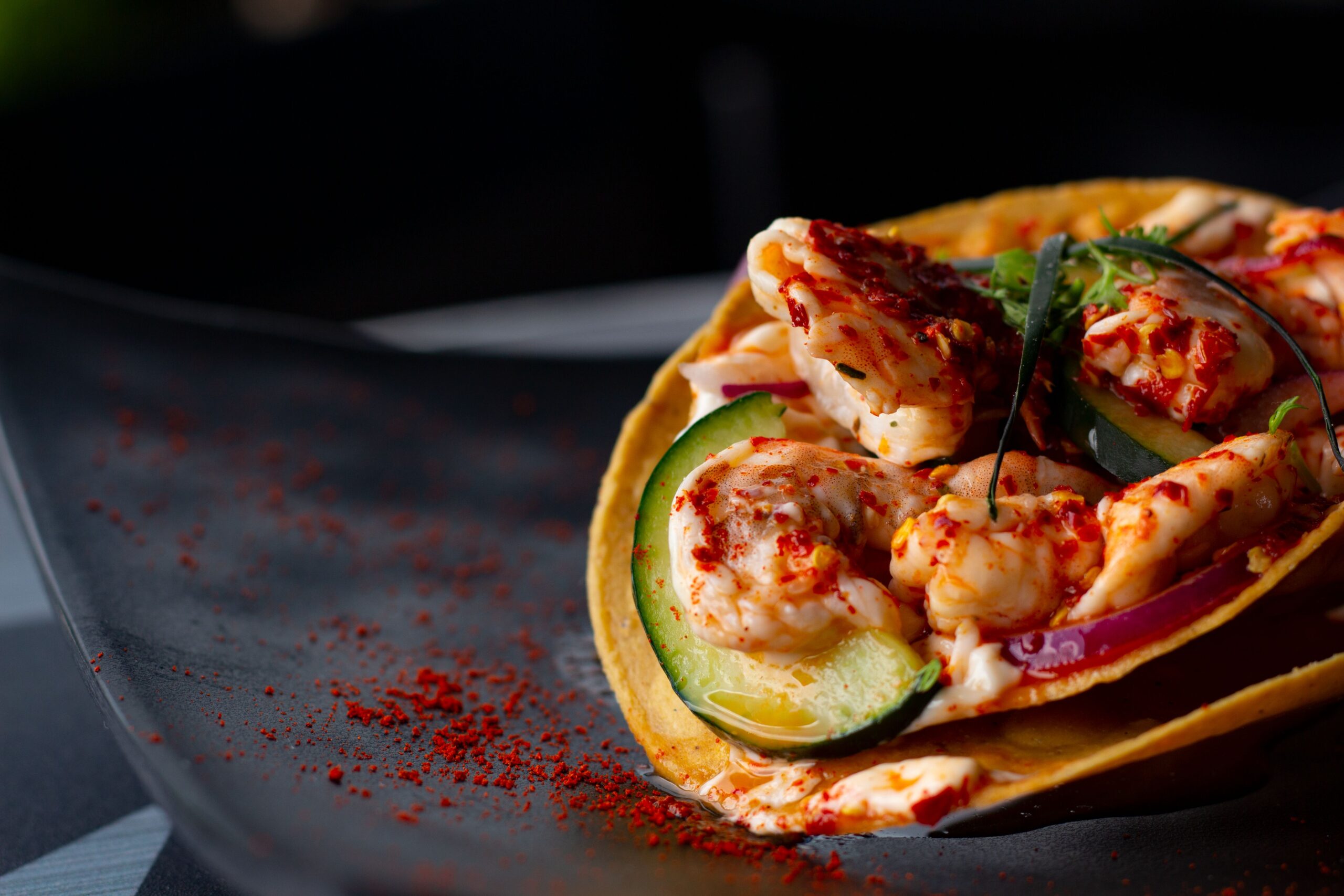 Finished grilled shrimp tacos with cabbage slaw crema and lime from a Lion gas grill rotisserie basket recipe