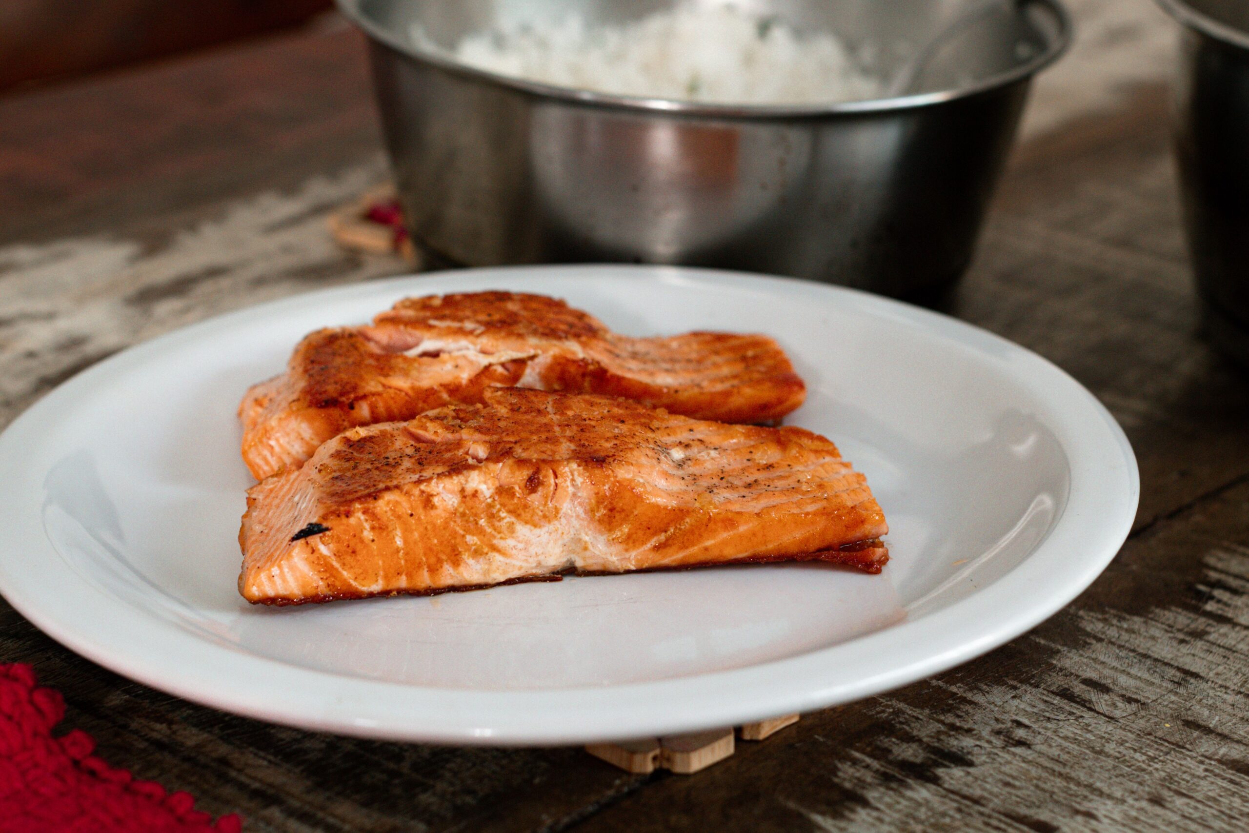 Flawless luxury seafood presentation highlighting fully cooked smoked salmon on a gas grill
