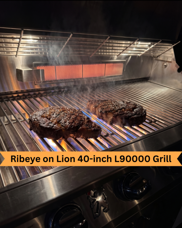How to grill a ribeye on a gas grill: two ribeye steaks searing on a Lion 40-inch LP9000 gas grill