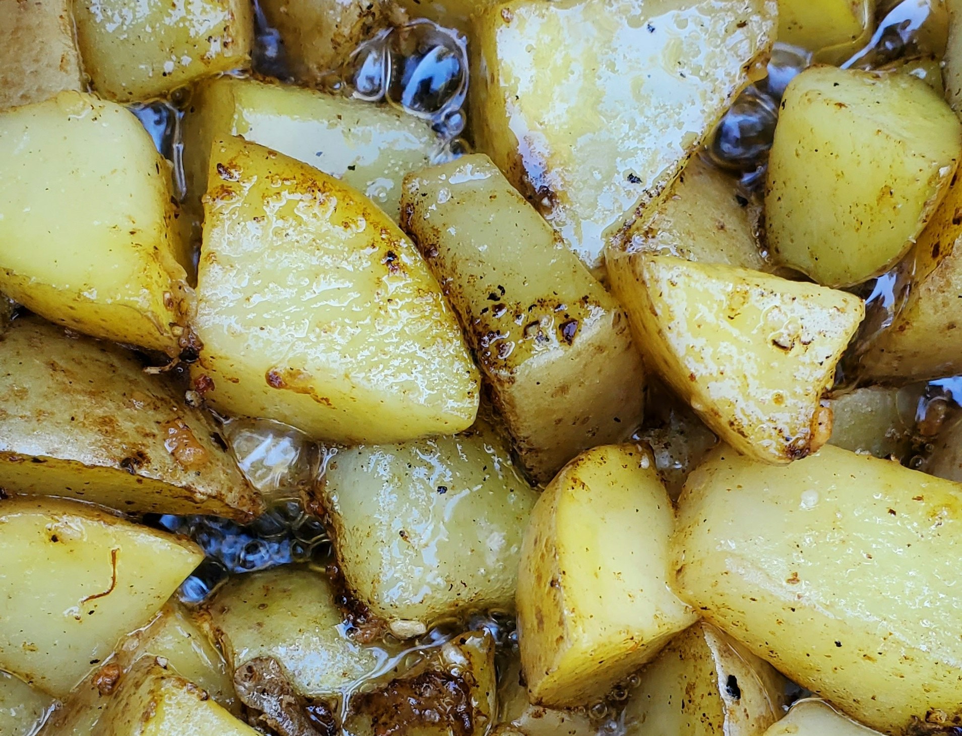 Raw seasoned baby potatoes with olive oil and herbs ready for the Lion rotisserie basket